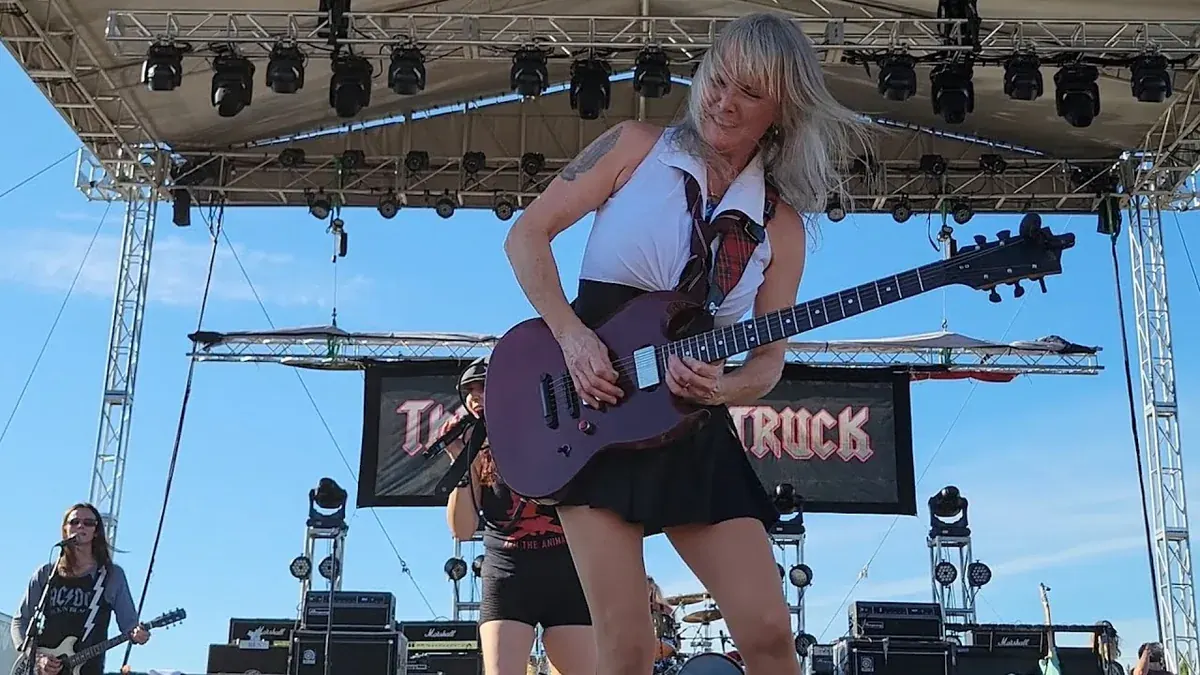 ThundHerStruck, the all-girl AC/DC tribute band from Los Angeles, performing Thunderstruck on an outdoor festival stage in 2022