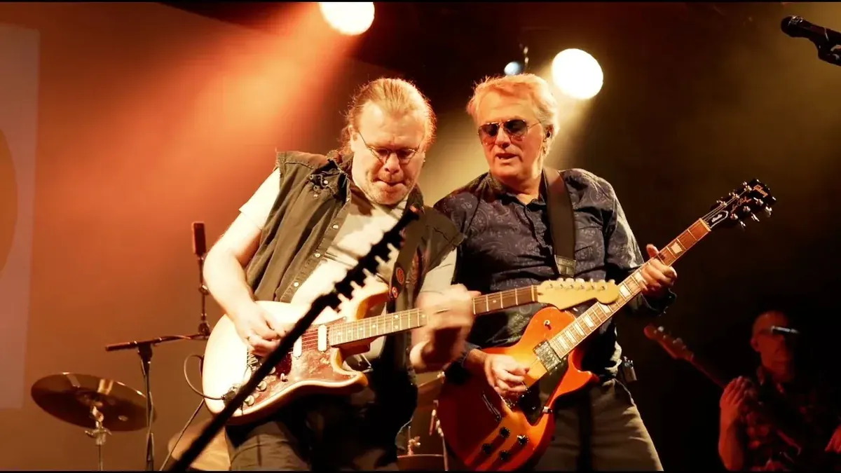 Two guitarists of The American Classic Rock Show playing side by side