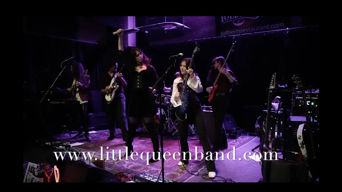 Little Queen, the Texas Heart tribute band, performing on a club stage