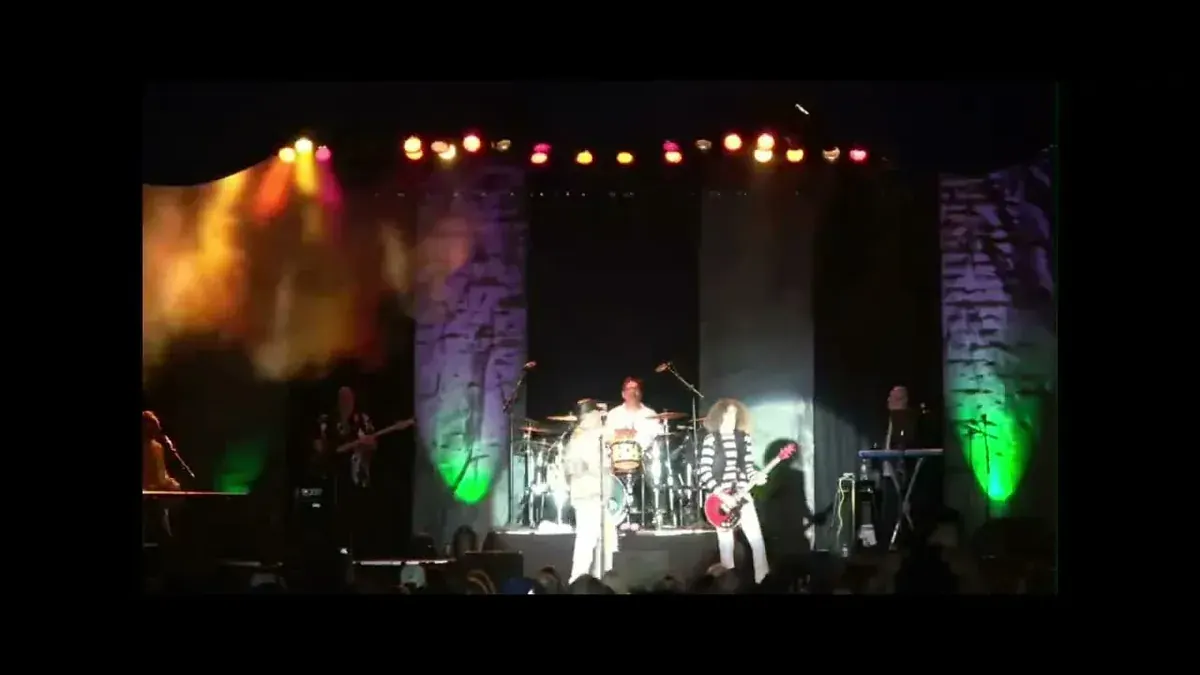 Celebrating Queen tribute band performing Stone Cold Crazy on an outdoor stage in Las Vegas