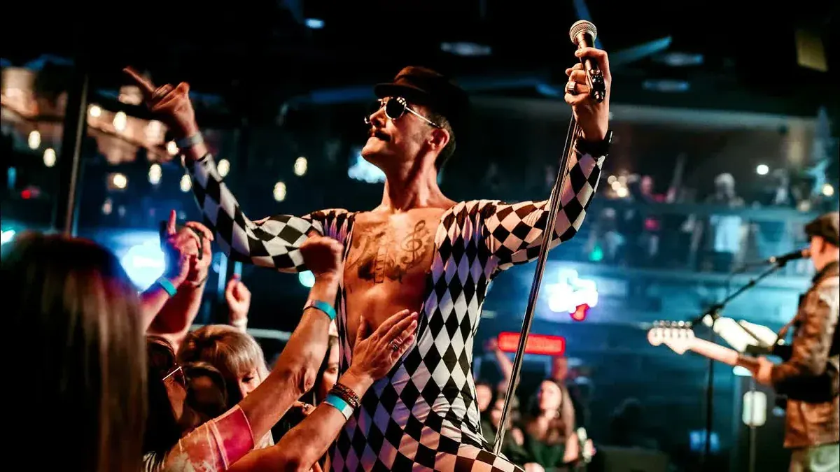 The Kings of Queen frontman in a harlequin bodysuit singing Don't Stop Me Now live in Roseville, California