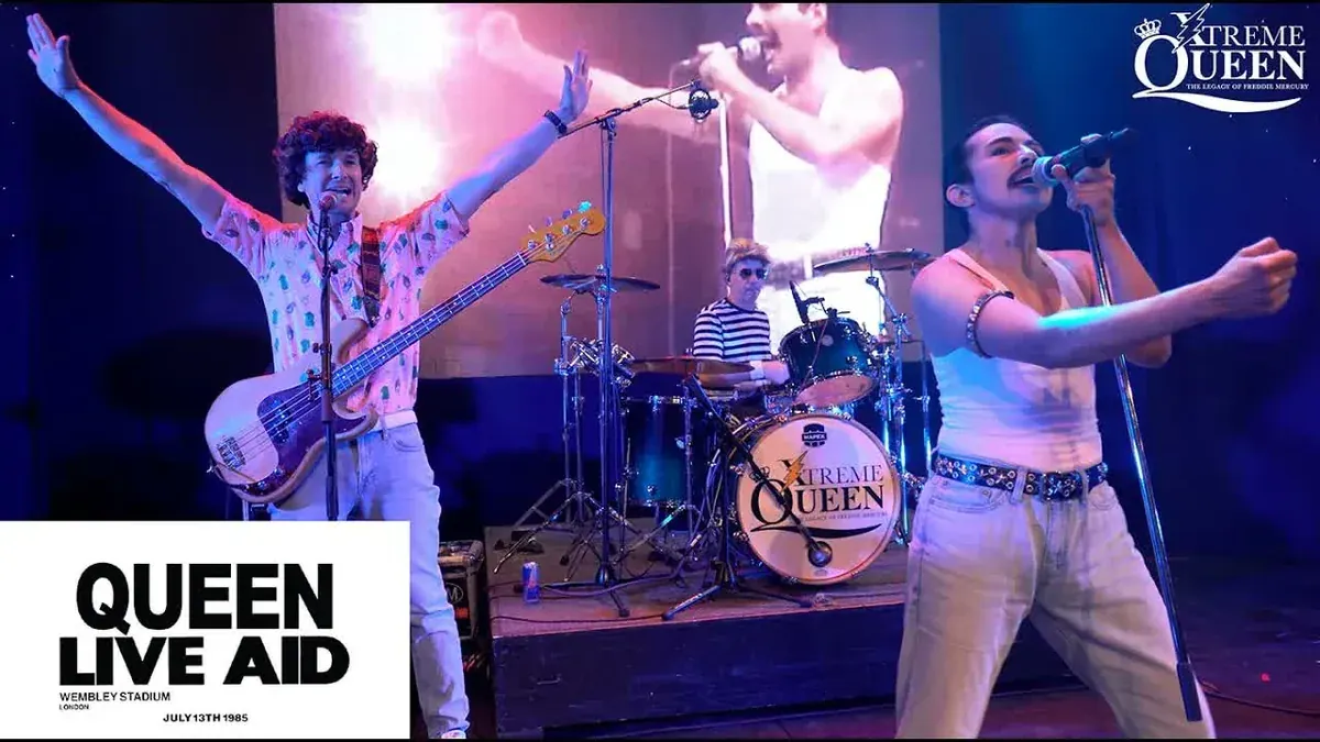 Xtreme Queen recreating the 1985 Live Aid set with a Queen Live Aid Wembley Stadium graphic on stage
